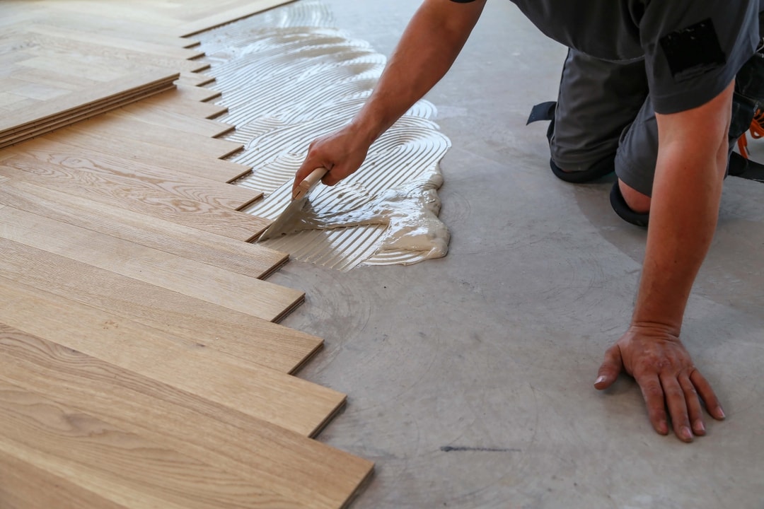 Fitter installing wood flooring