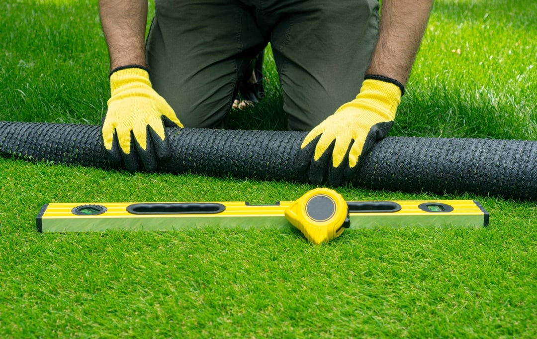 Fitter rolling out artificial grass